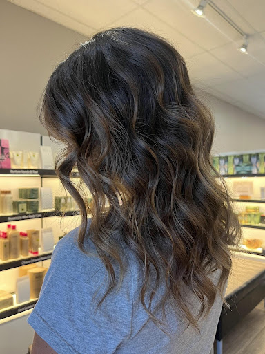 Side view of smoked suede fall balayage on wavy brunette hair, featuring soft highlights and natural dimension - Pure Salon Spa, KY