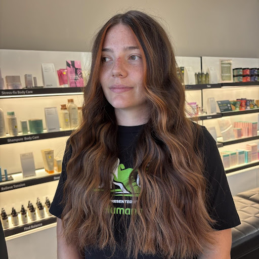Copper cashmere hair color on long wavy brunette hair with warm highlights and soft face-framing dimension. - Pure Salon Spa, KY