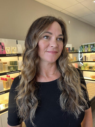 Mocha mousse balayage on wavy brunette hair with soft face-framing highlights and dimensional curls in a salon setting - Pure Salon Spa, KY