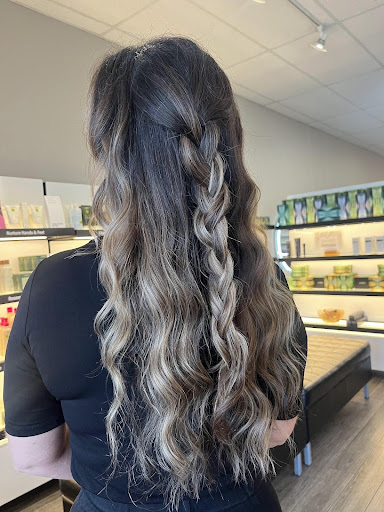 Mocha mousse balayage on long wavy brunette hair styled with a loose braid to show dimensional highlights in a salon setting. - Pure Salon Spa, KY