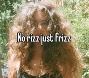 Person with very frizzy, voluminous hair stands outdoors; overlaid text reads, “No rizz just frizz”—thanks to that classic Louisville humidity. - Pure Salon Spa, KY